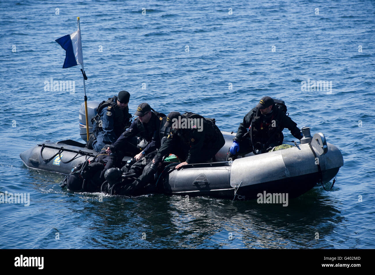 Canadian divers being helped aboard their boat. Stock Photo