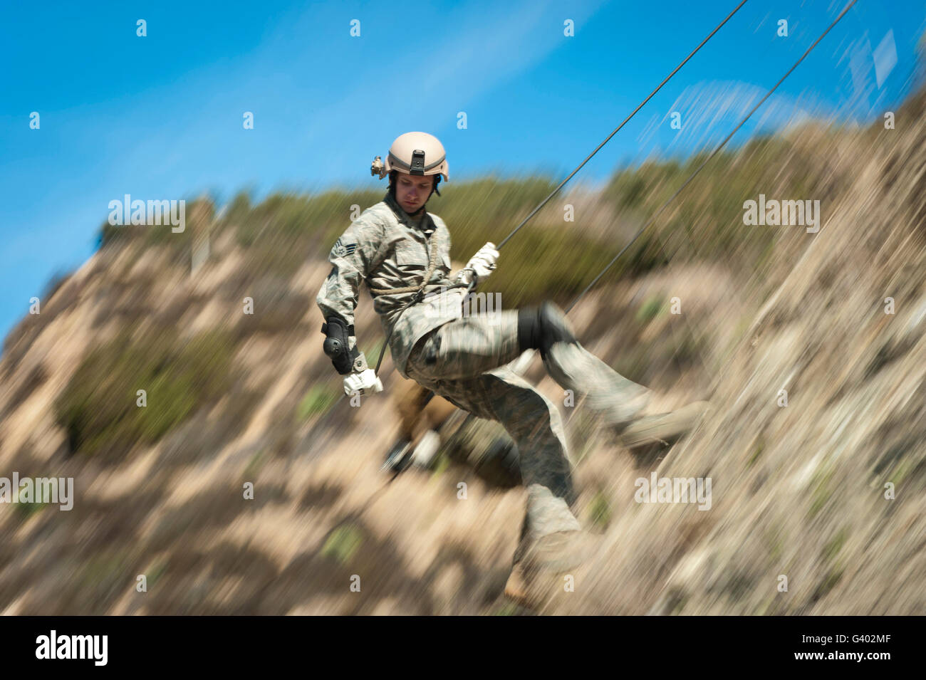 U.S. Air Force Airman practices rappelling during a field exercise ...
