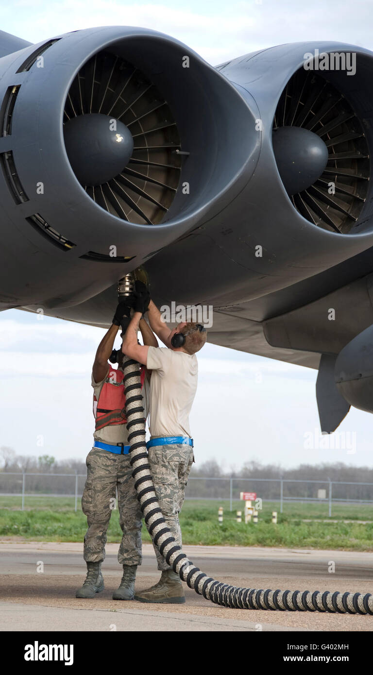 Airmen disconnect an aircraft hose from a B-52H Stratofortress engine. Stock Photo
