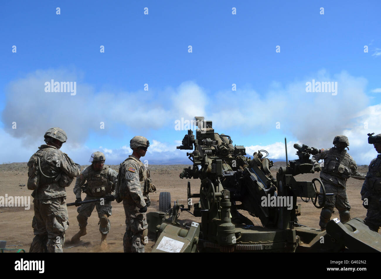 Soldiers firing the M777 howitzer cannon. Stock Photo