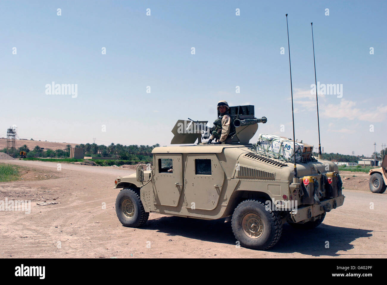 U.S. Marine pulls security on top of a M1114 Armored HMMWV Stock Photo