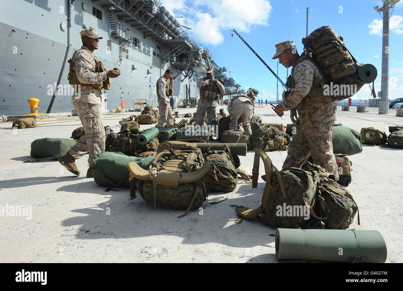 Marines move gear during an embarkation aboard USS Bonhomme Richard. Stock Photo