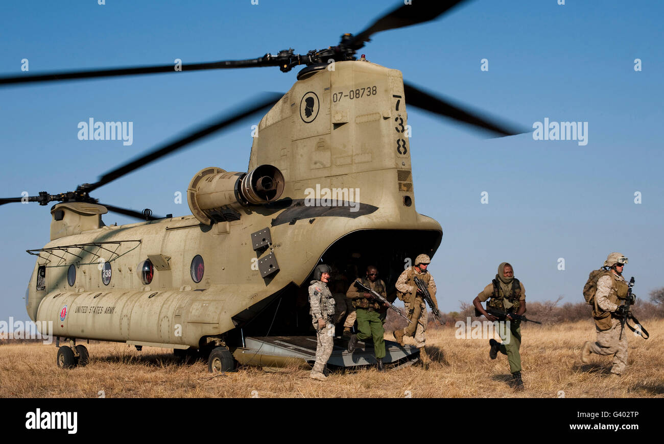 U.S. Marines exit a Hawaii Army National Guard CH-47F Chinook helicopter. Stock Photo