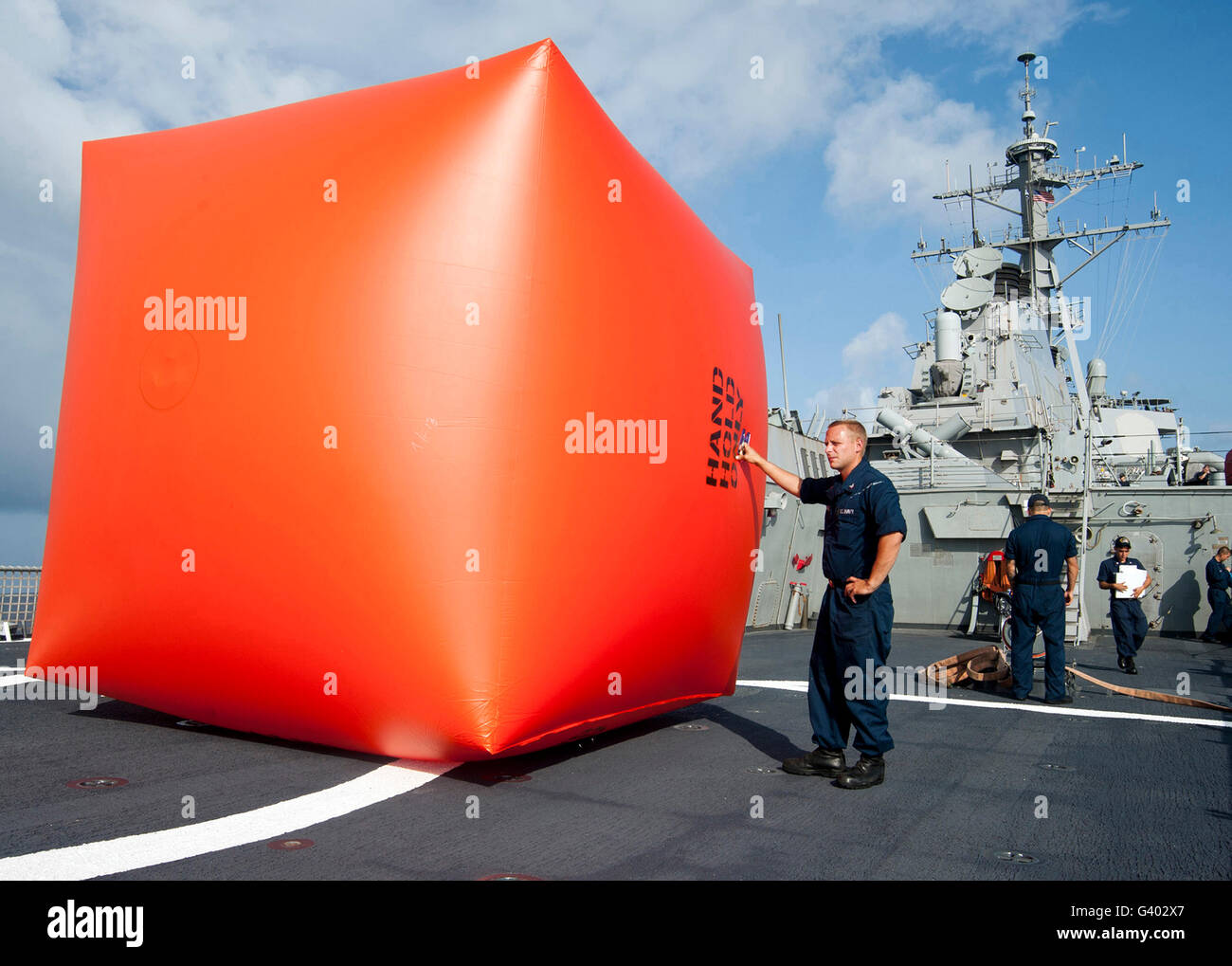 Sailors prepare to deploy a killer tomato for a gunnery exercise aboard USS Decatur. Stock Photo