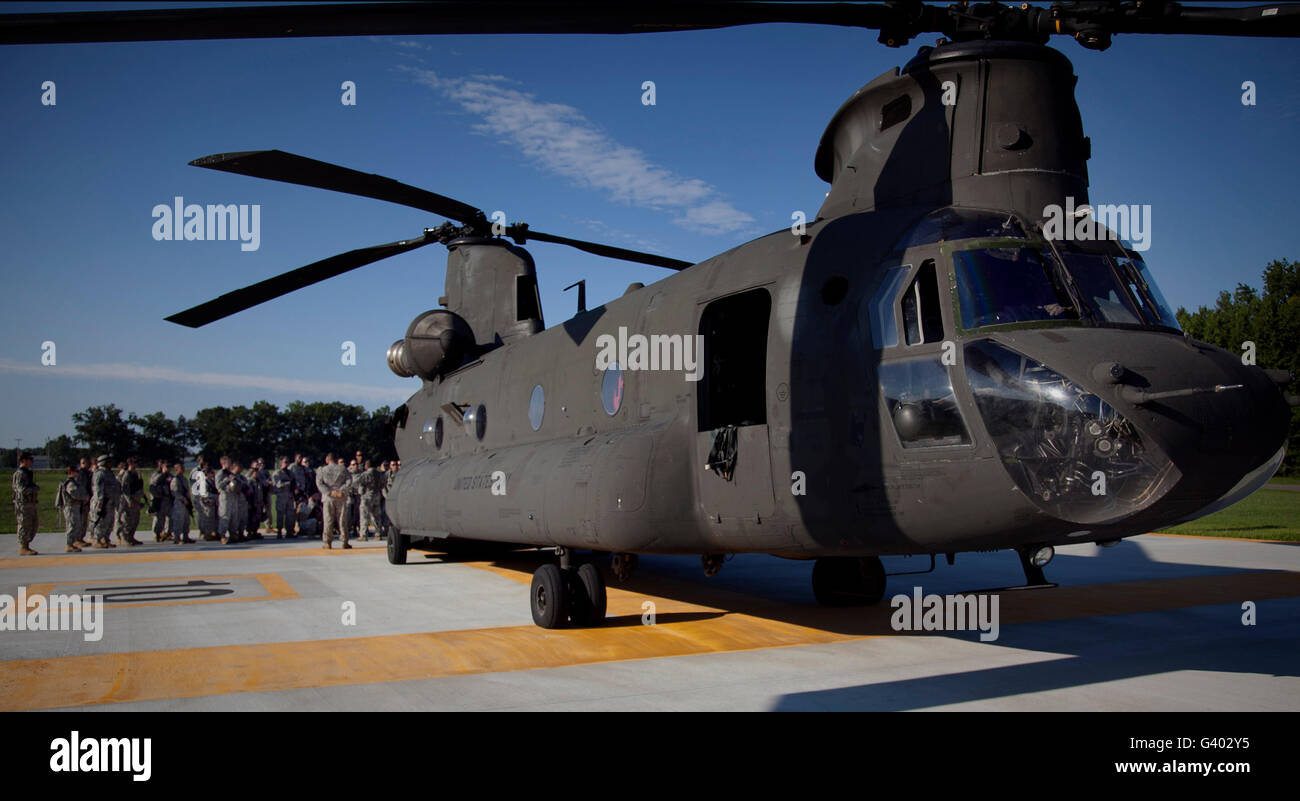 Soldiers being briefed behind a CH-47 Chinook helicopter. Stock Photo