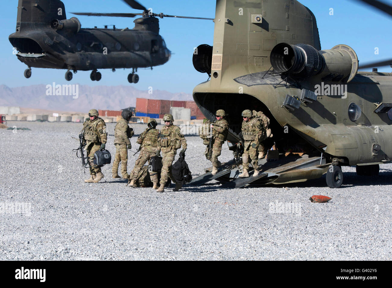 U.S. soldiers offload a CH-47 Chinook helicopter. Stock Photo