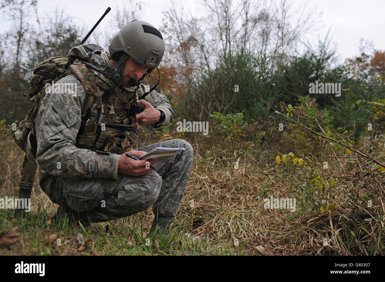 Airman reads coordinates to aircrew during a field training exercise. Stock Photo