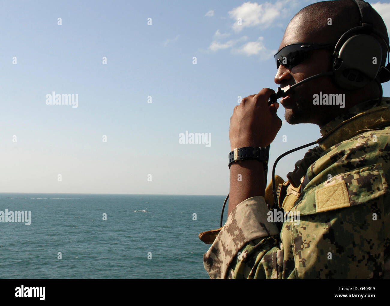 Soldier instructs small boat maneuvers during a training exercise. Stock Photo