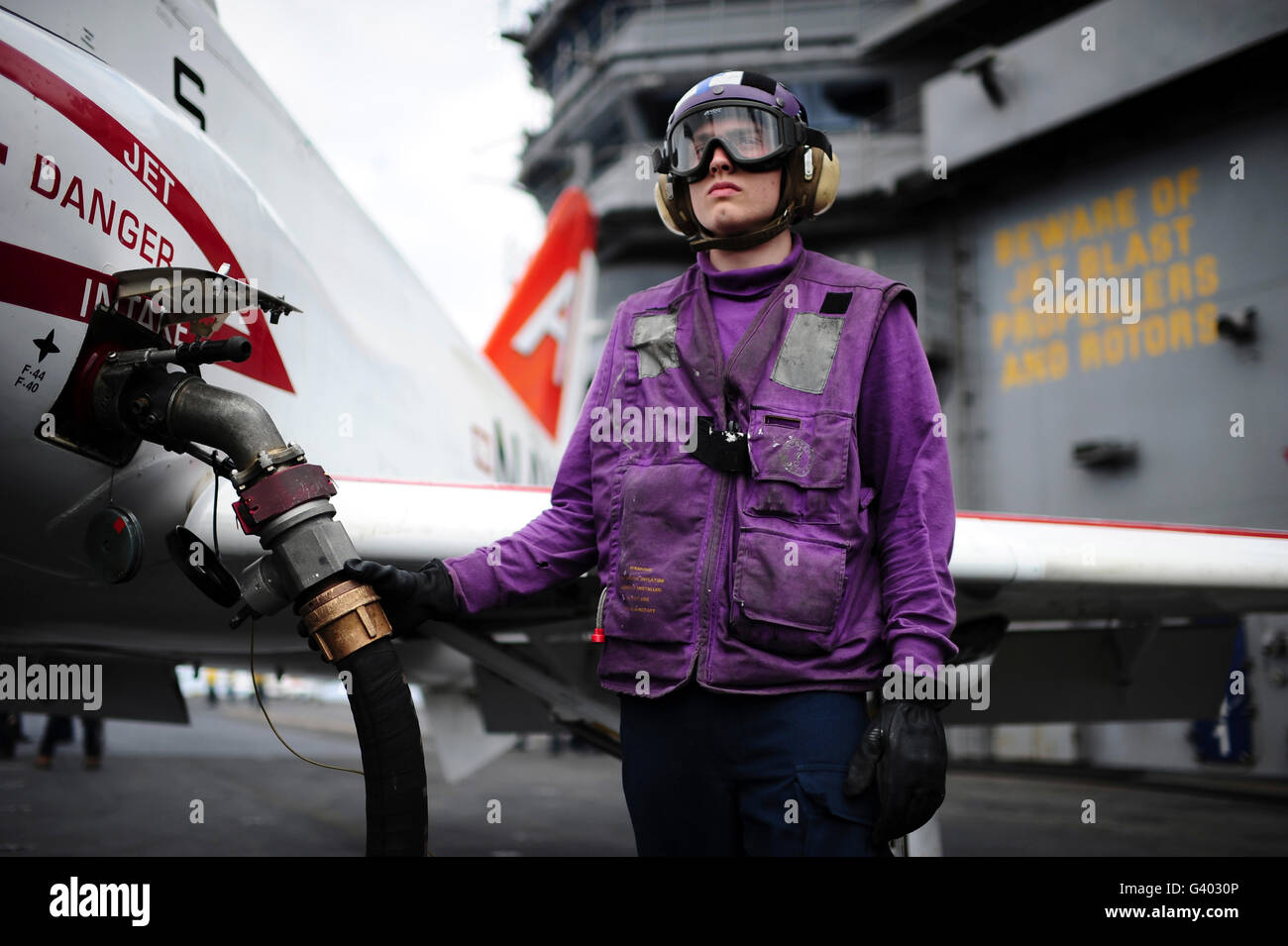 Aviation Boatswain's Mate fuels a T-45C Goshawk training aircraft. Stock Photo