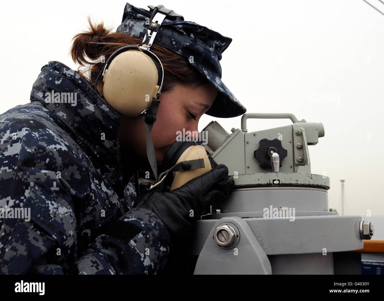 Seaman uses a sound-powered phone to relay information aboard USS Blue Ridge. Stock Photo