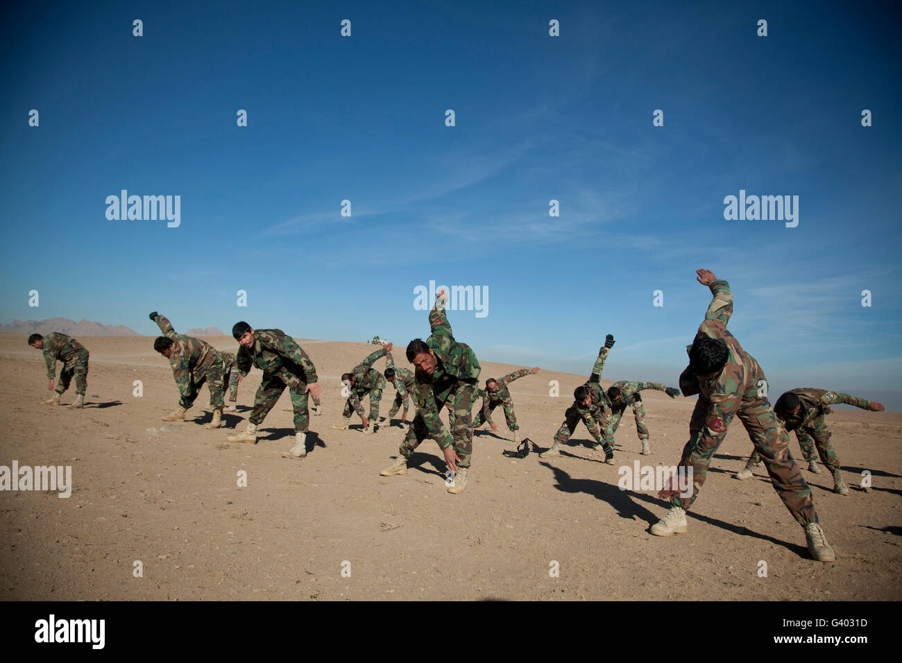 Afghan National Army commandos do stretches during training. Stock Photo