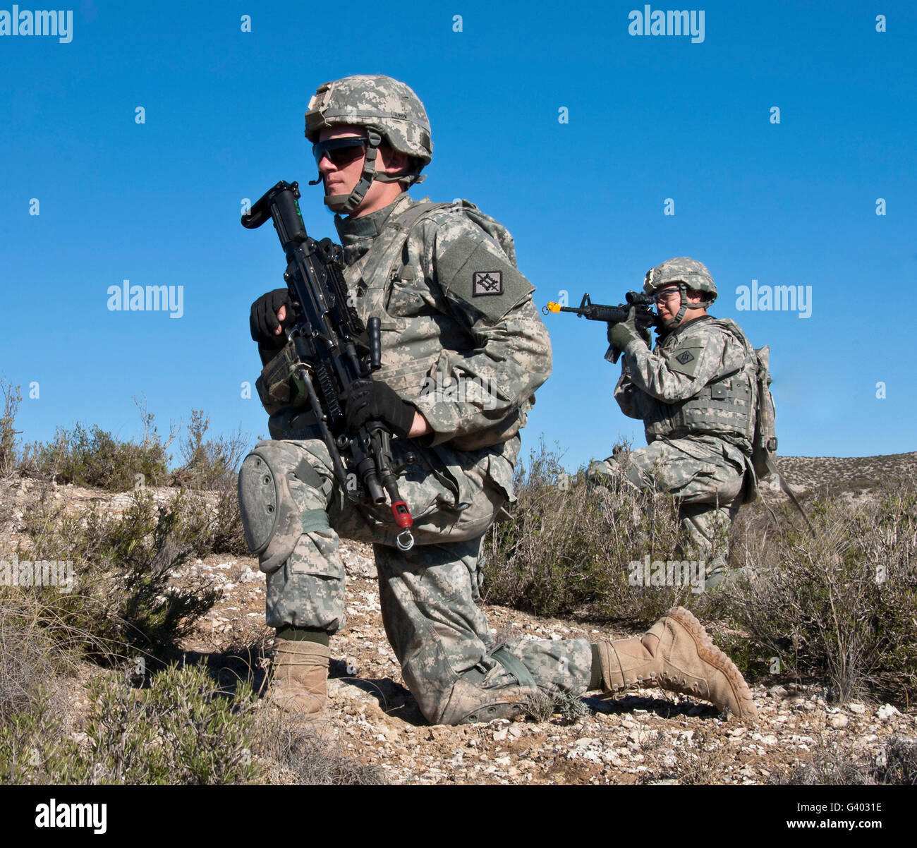U.S. Army soldiers scan the terrain for suspected opposing forces in Spain. Stock Photo