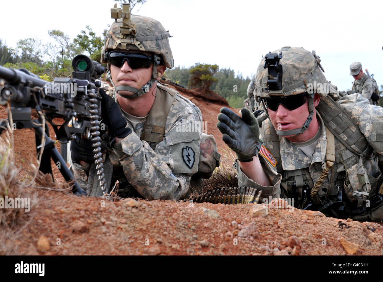 Soldiers point out possible enemy targets during a field exercise. Stock Photo