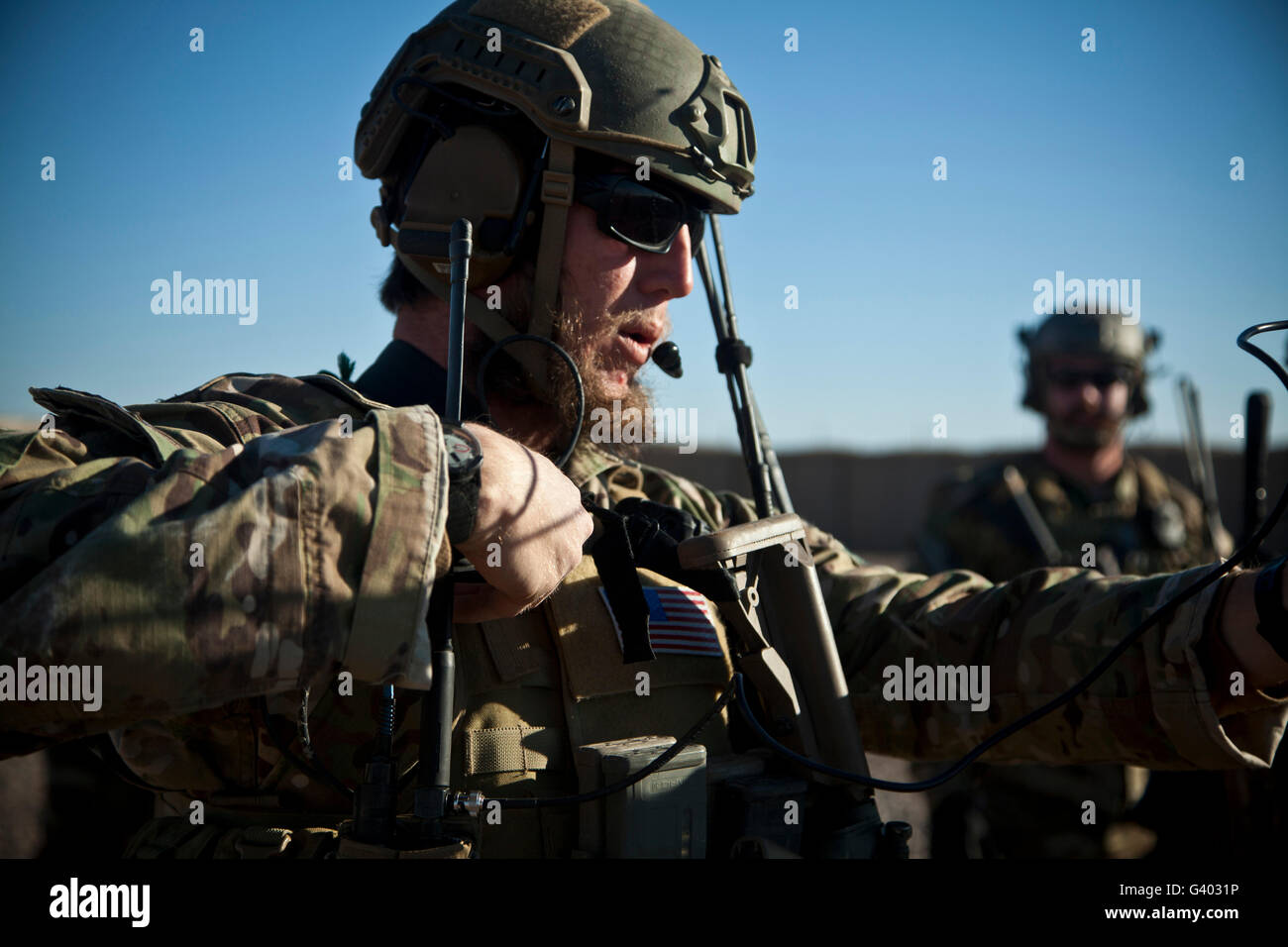 A coalition force member sets up communication with a UH-60 Black Hawk. Stock Photo