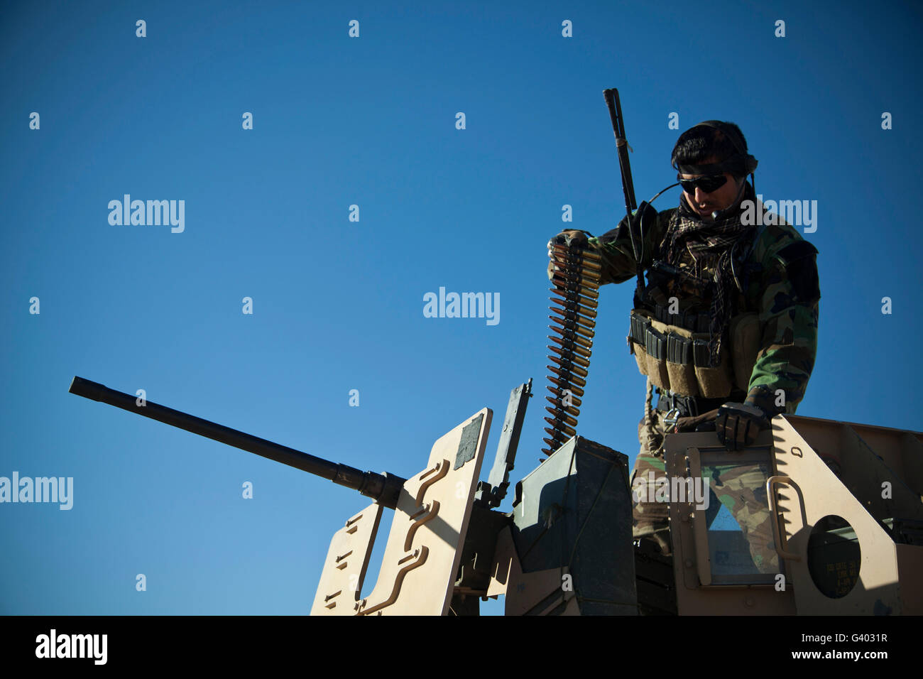 An Afghan National Army soldier prepares a .50-caliber machine gun. Stock Photo