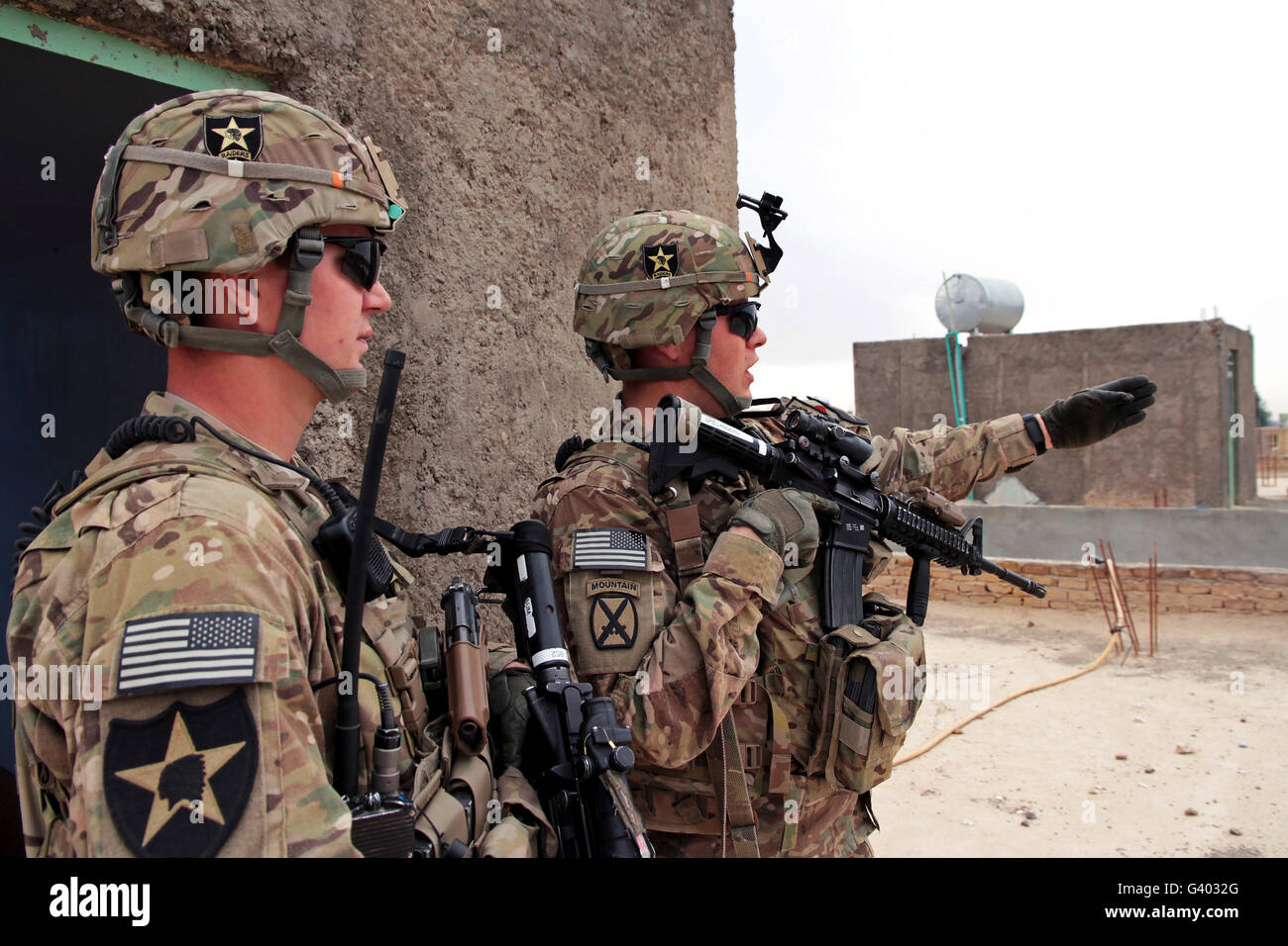 U.S. Army soldier points out a landmark to fellow team member. Stock Photo