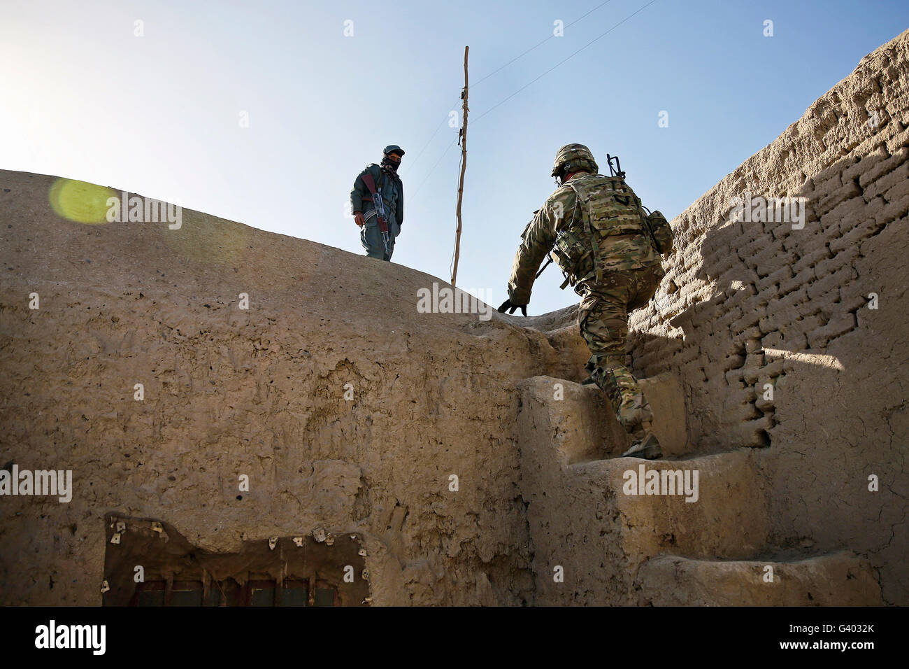 U.S. Army soldier climbs stairs to the roof of the Farah City prison. Stock Photo