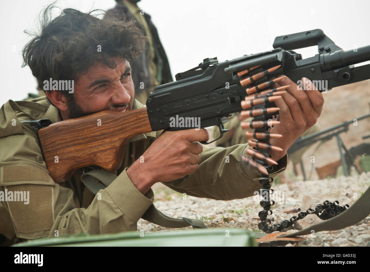 An Afghan Local Police officer fires a machine gun during live-fire training. Stock Photo