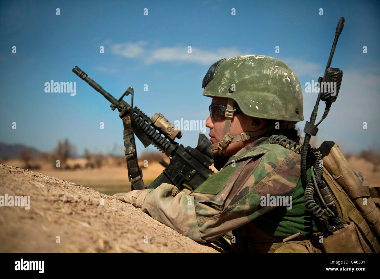 A coalition force member provides overwatch in Afghanistan. Stock Photo
