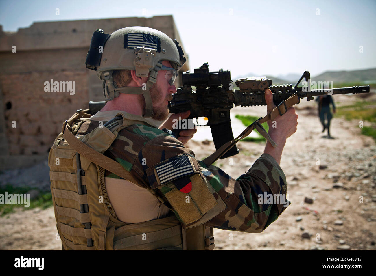 A coalition force member maintains security in Afghanistan. Stock Photo