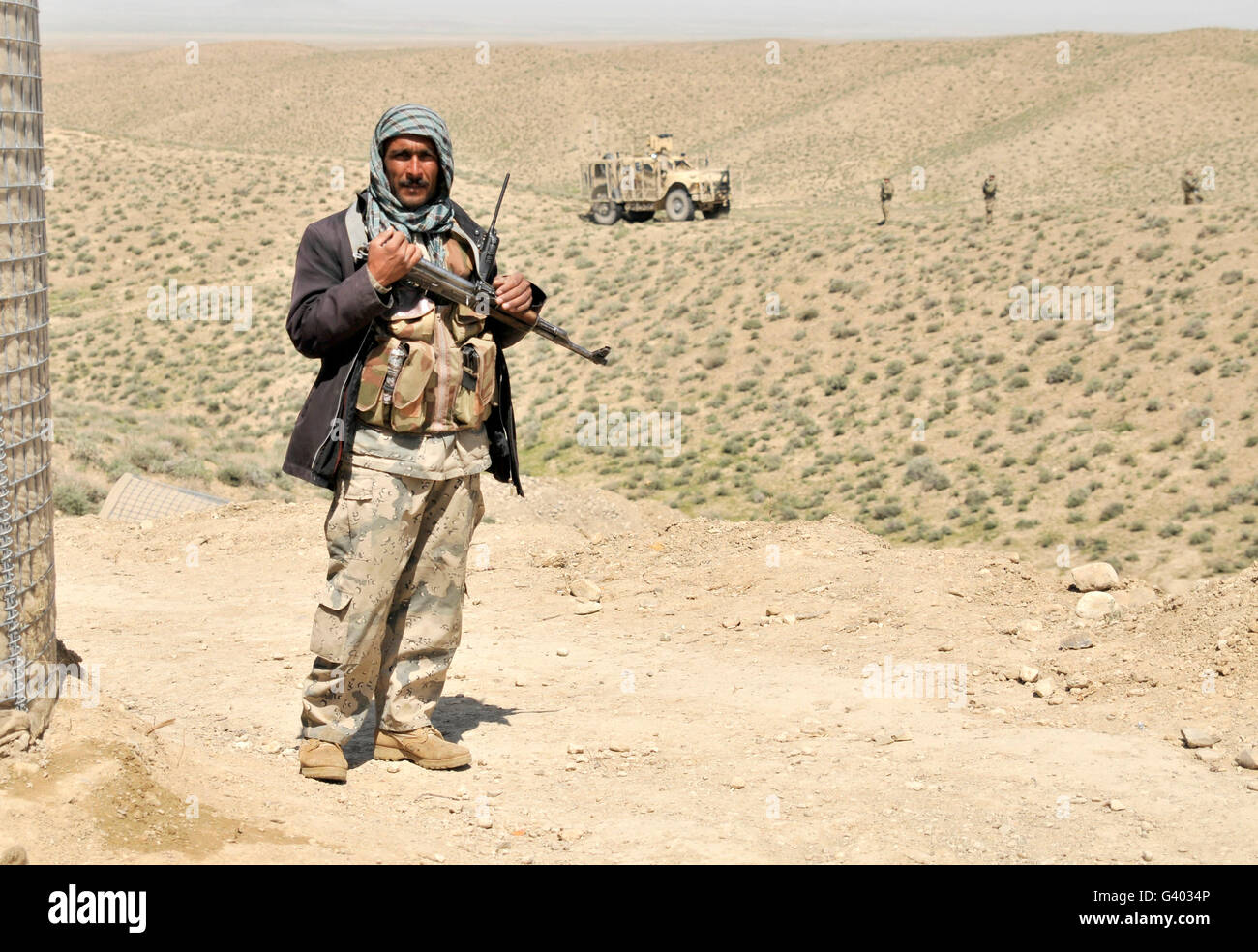 An Afghan Border Policeman secures the entrance to a checkpoint. Stock Photo