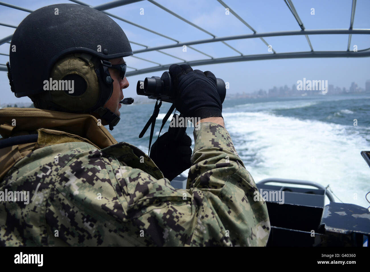 Soldier searches for surface contacts while patrolling San Diego Bay. Stock Photo