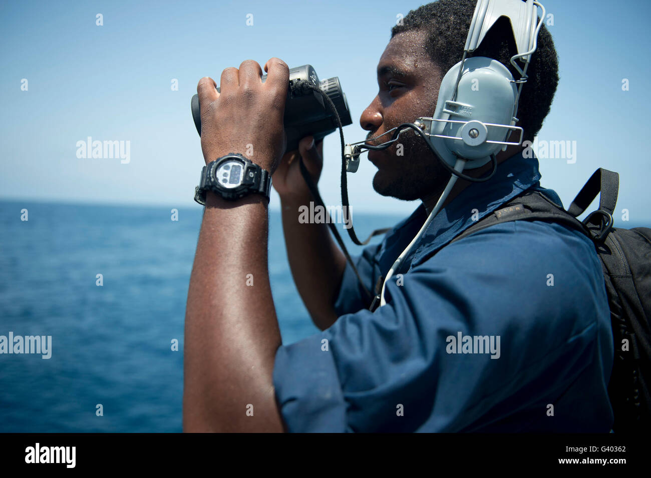 Seaman stands lookout aboard USS William P. Lawrence. Stock Photo