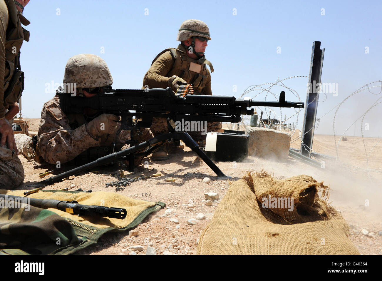 Soldier fires an M240B machine gun during marksmanship training. Stock Photo