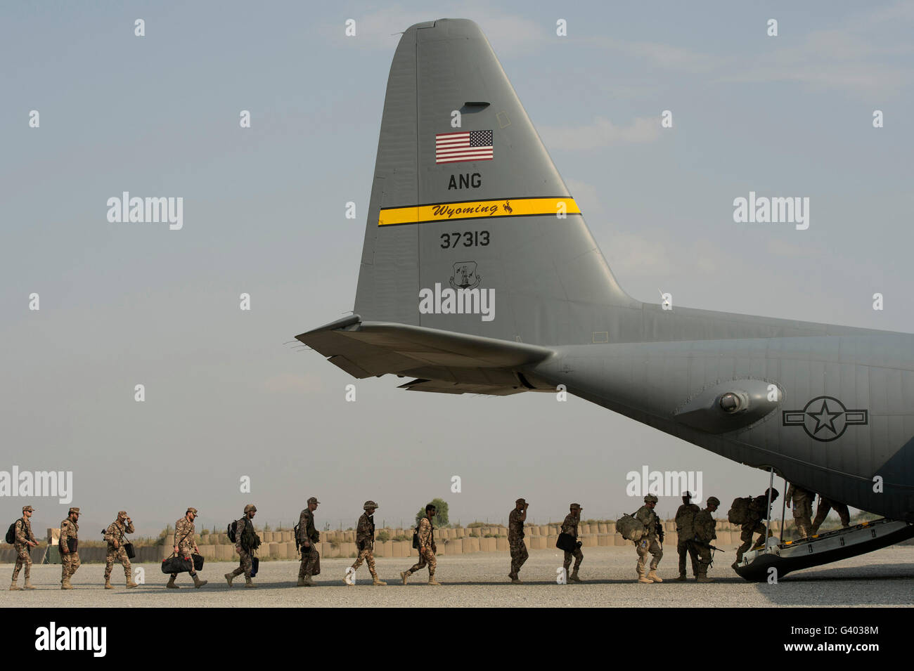 U.S. Army and Jordanian soldiers board a C-130 Hercules. Stock Photo