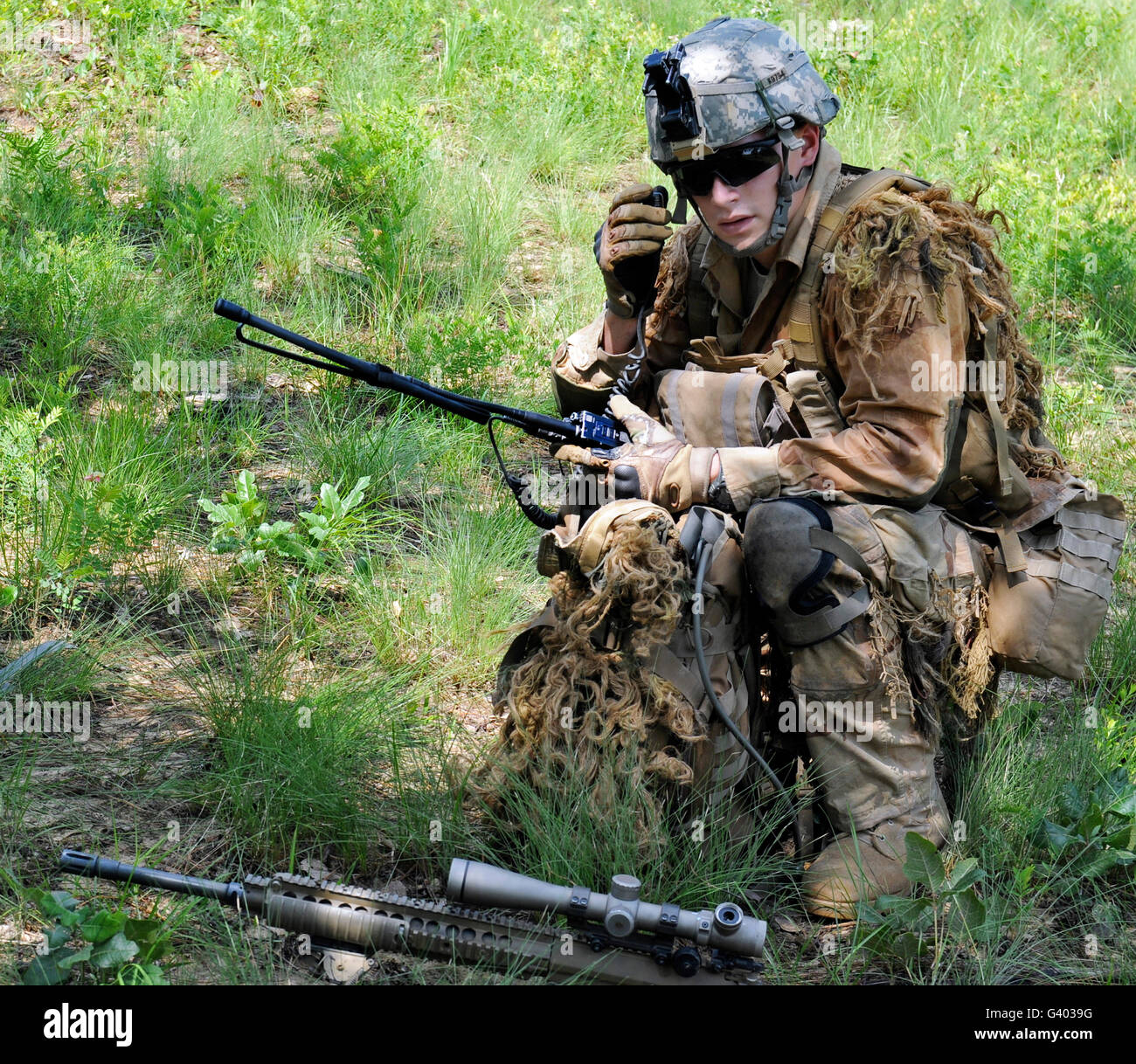 A sniper conducts a radio check. Stock Photo