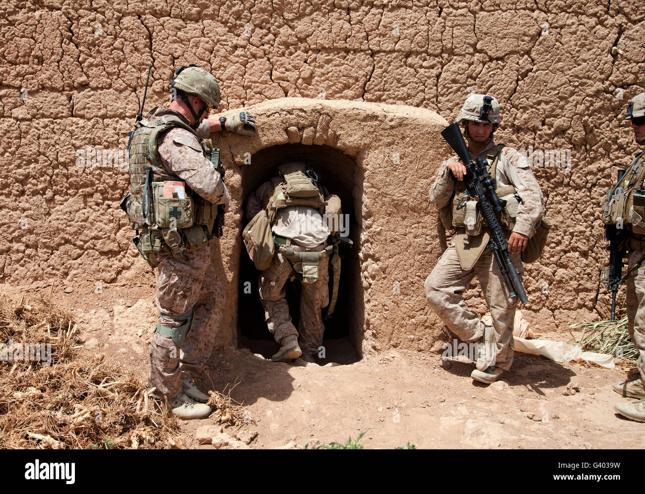 U.S. Marines search a compound in Afghanistan. Stock Photo