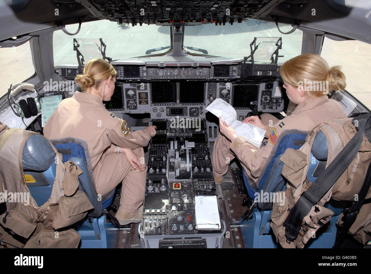 Flight Captains review flight information before they depart in a C-17 Globemaster III. Stock Photo