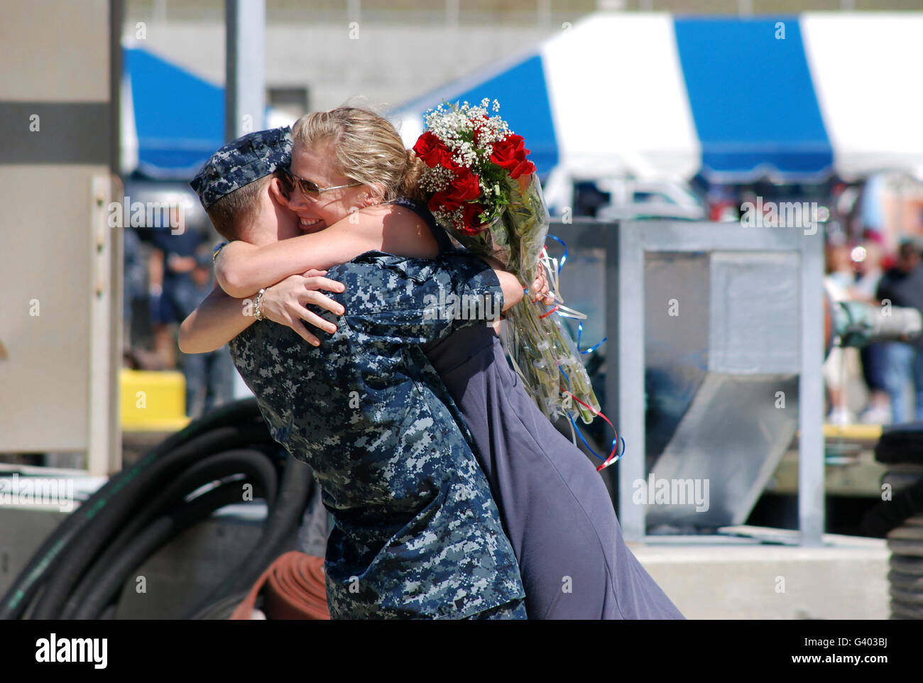 Machinist Mate is welcomed home by his wife during a homecoming celebration. Stock Photo