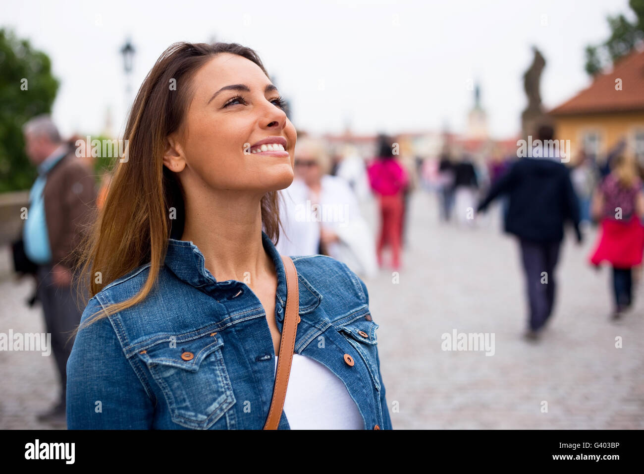 happy young woman smiling on charles bridge in Prague Stock Photo