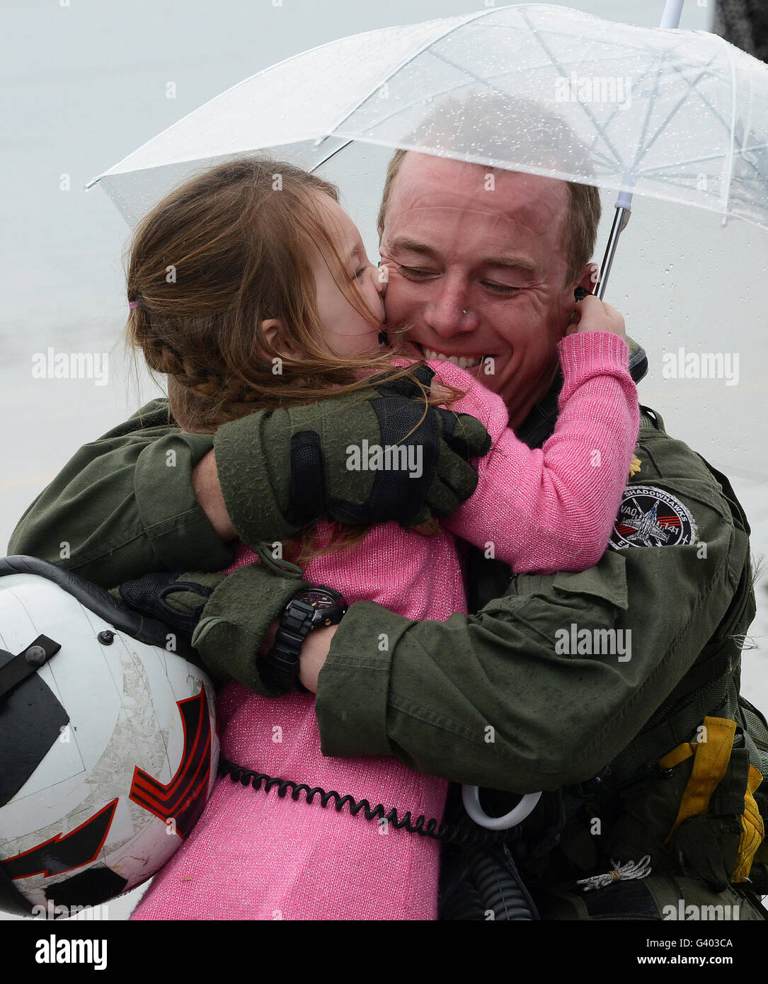 U.S. aviator hugs his daughter during a homecoming celebration. Stock Photo