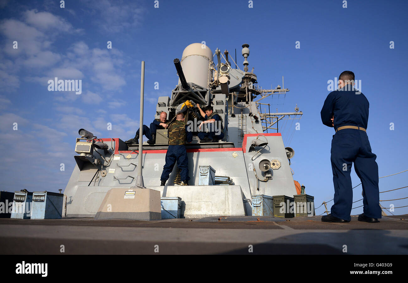 Sailors load ammunition into a close-in weapon system aboard USS Bulkeley. Stock Photo