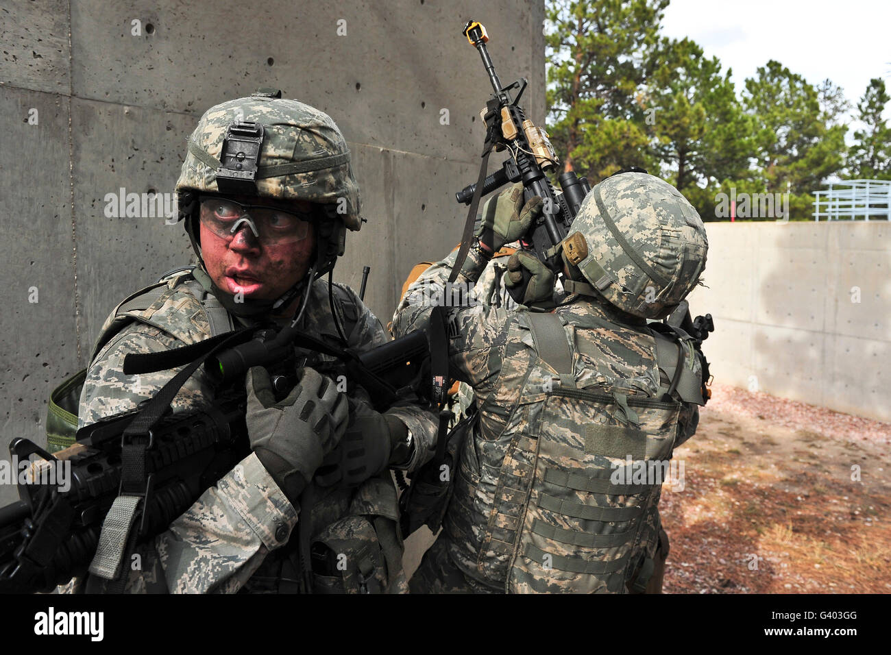 Airman provides rear protection against potential enemy surprises during a raid. Stock Photo