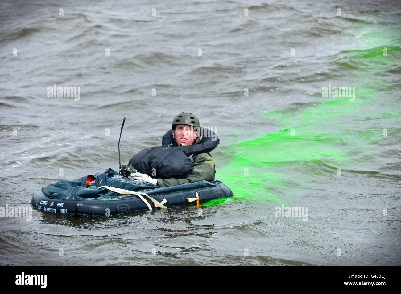 A downed pilot uses radio communication and sea dye to provide his location. Stock Photo