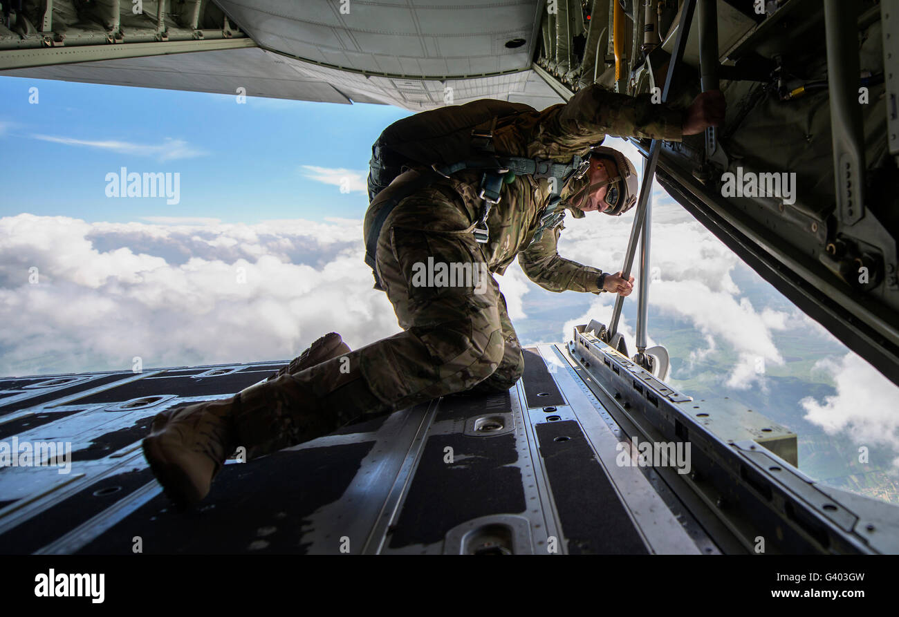 U.S. Army Soldier looks out the back ramp of a C-130J Super Hercules. Stock Photo