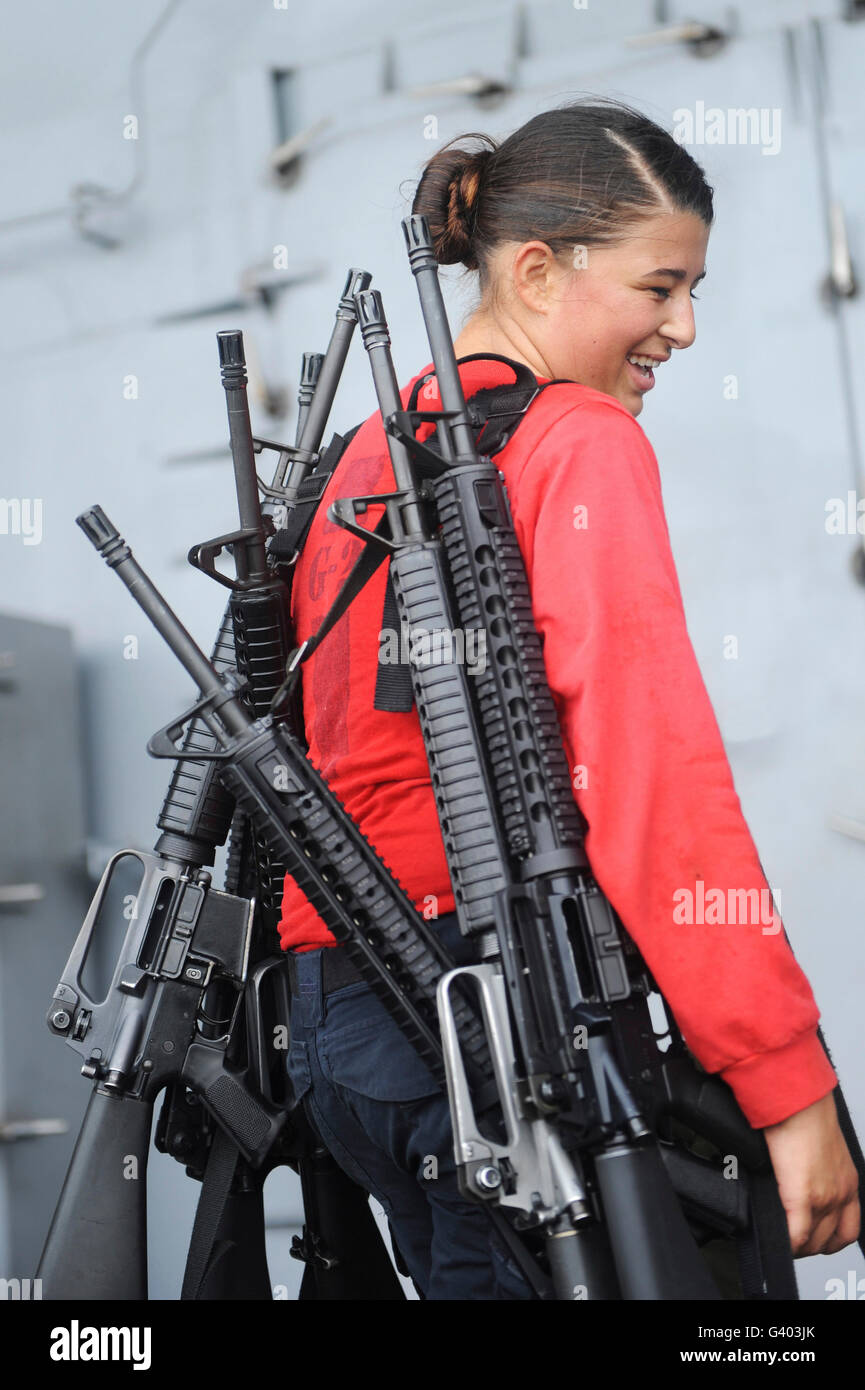 Gunner's Mate Seaman carrying rifles. Stock Photo
