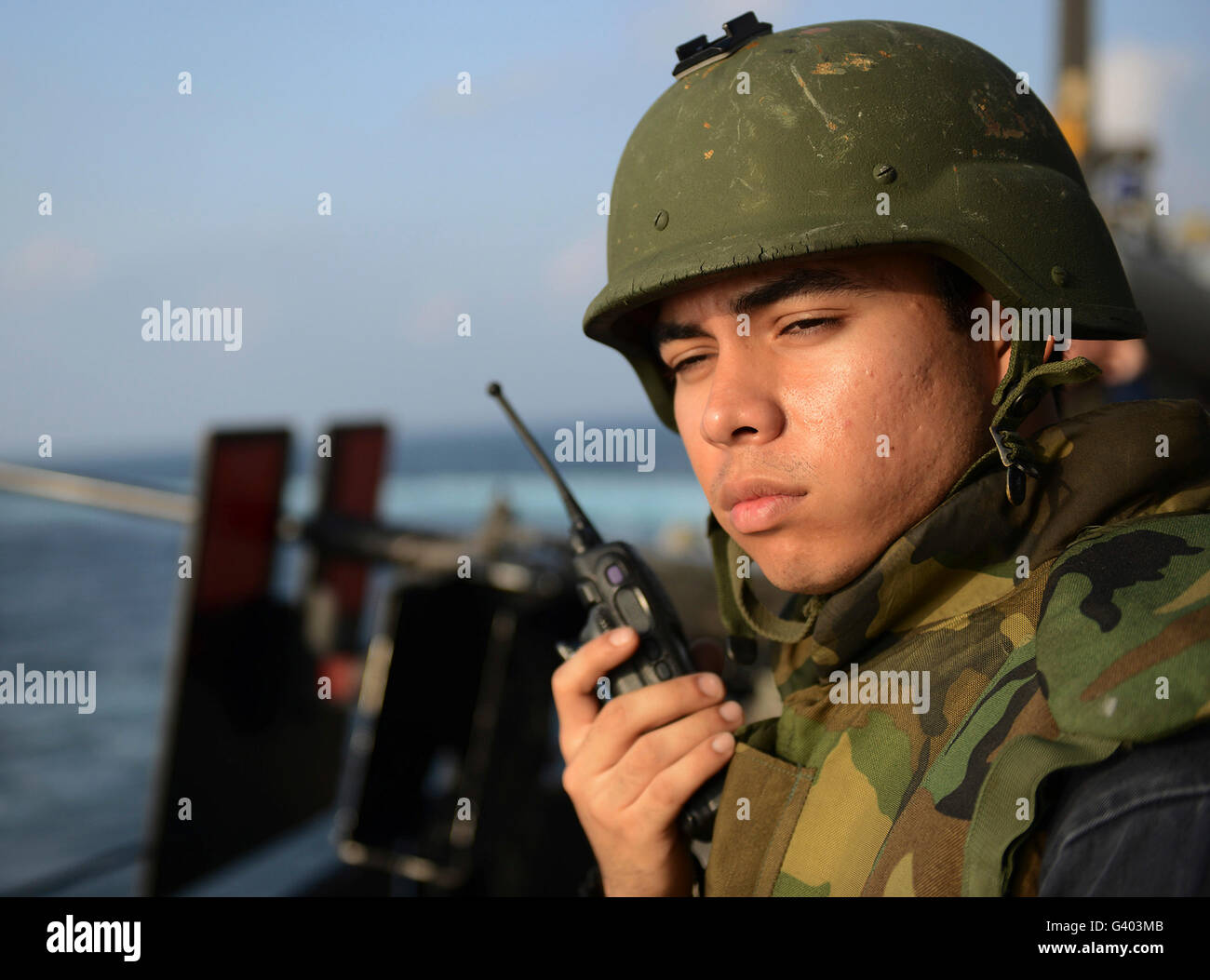 U.S. Navy Machinist's Mate radios the officer of the deck. Stock Photo