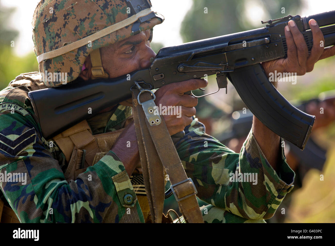 Maldivian Marine fires an AK-47 service rifle. Stock Photo