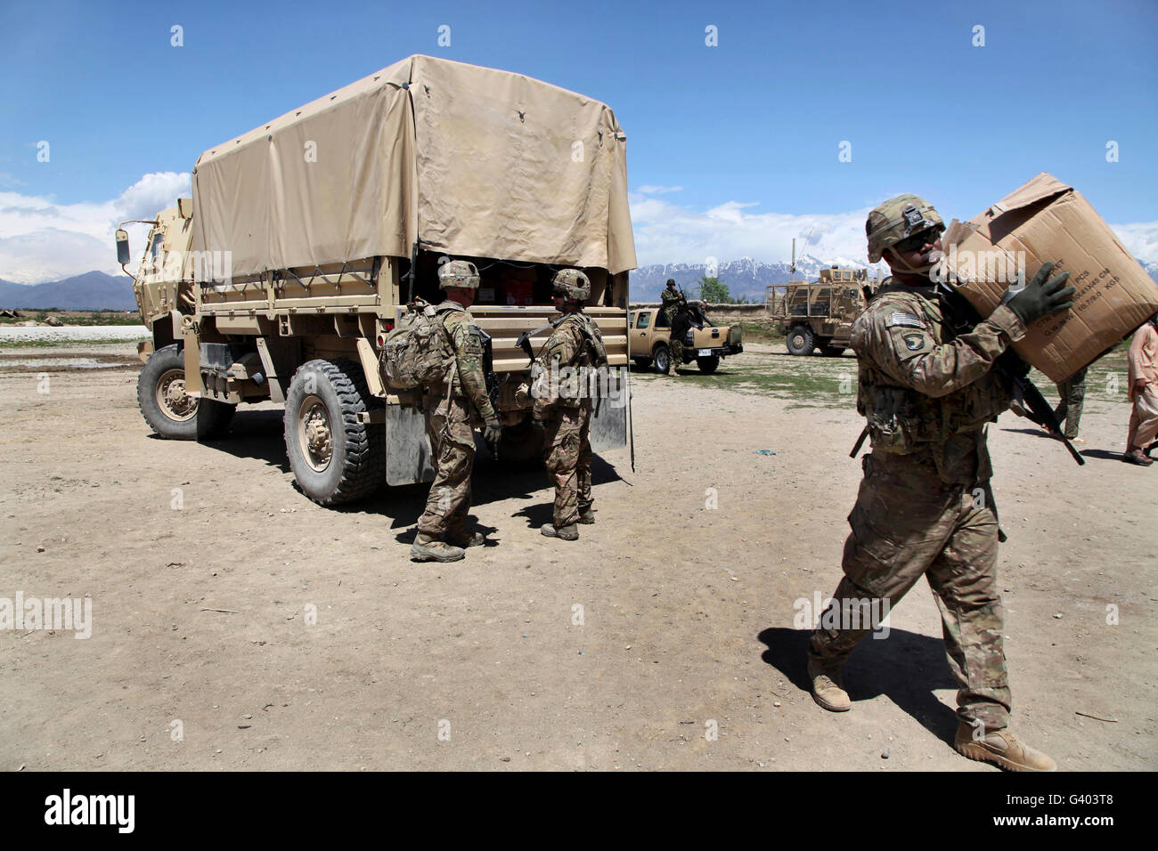 U.S. Army Soldiers assist the Afghan Military Police with a humanitarian aid event. Stock Photo