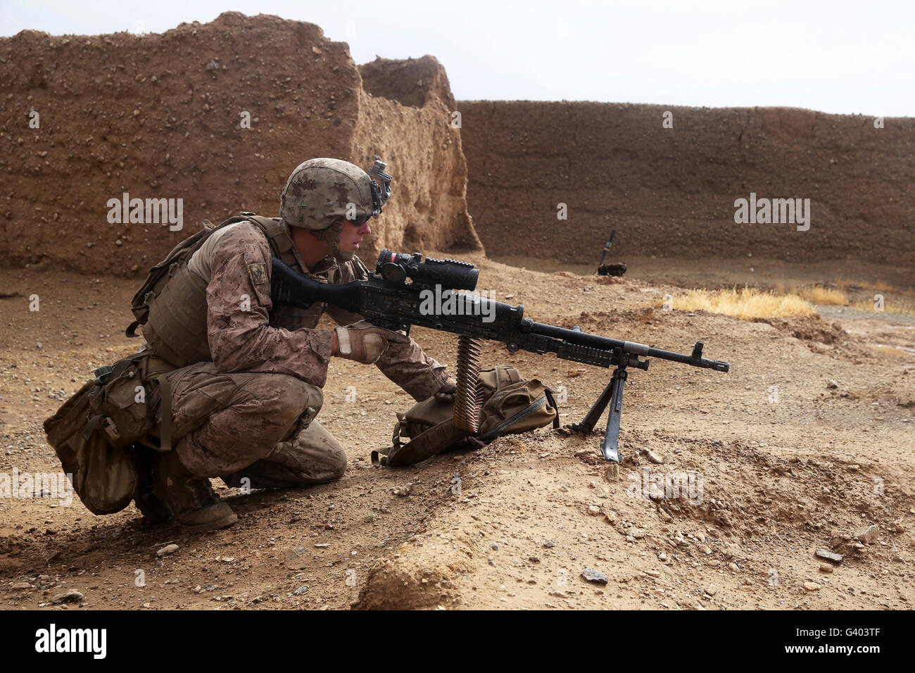 .S. Marine gunner provides security with an M240B medium machine gun. Stock Photo