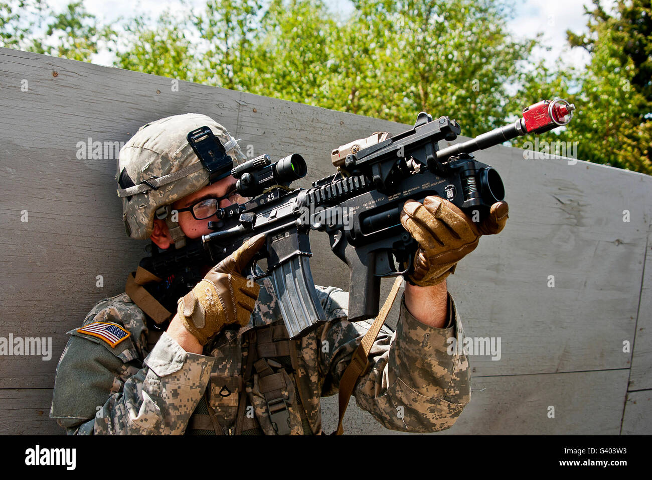 A U.S. Army paratrooper provides security at a mock village. Stock Photo