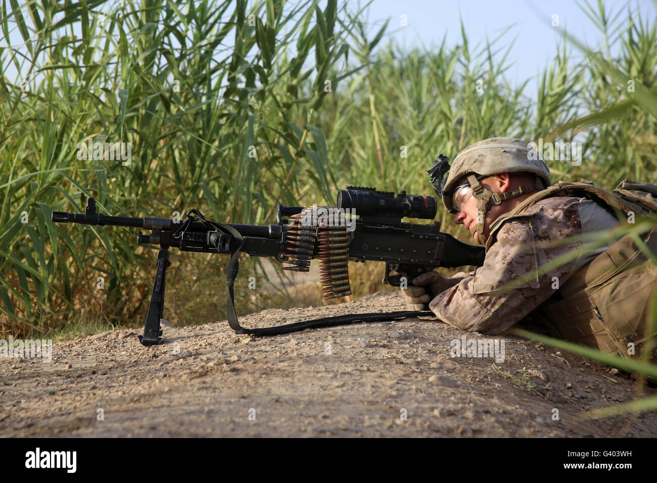 U.S. Marine provides security with an M240B medium machine gun. Stock Photo