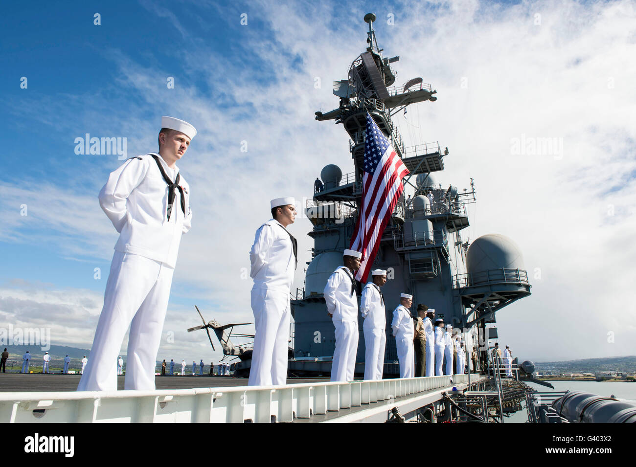 Sailors man the rails as aboard USS Peleliu. Stock Photo
