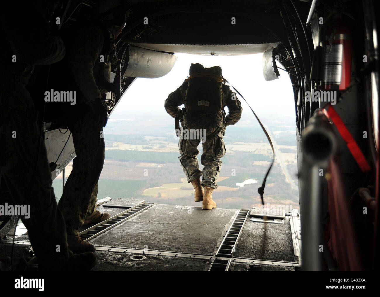 U.S. Navy SEALs jump from a CH-46E Sea Knight helicopter. Stock Photo