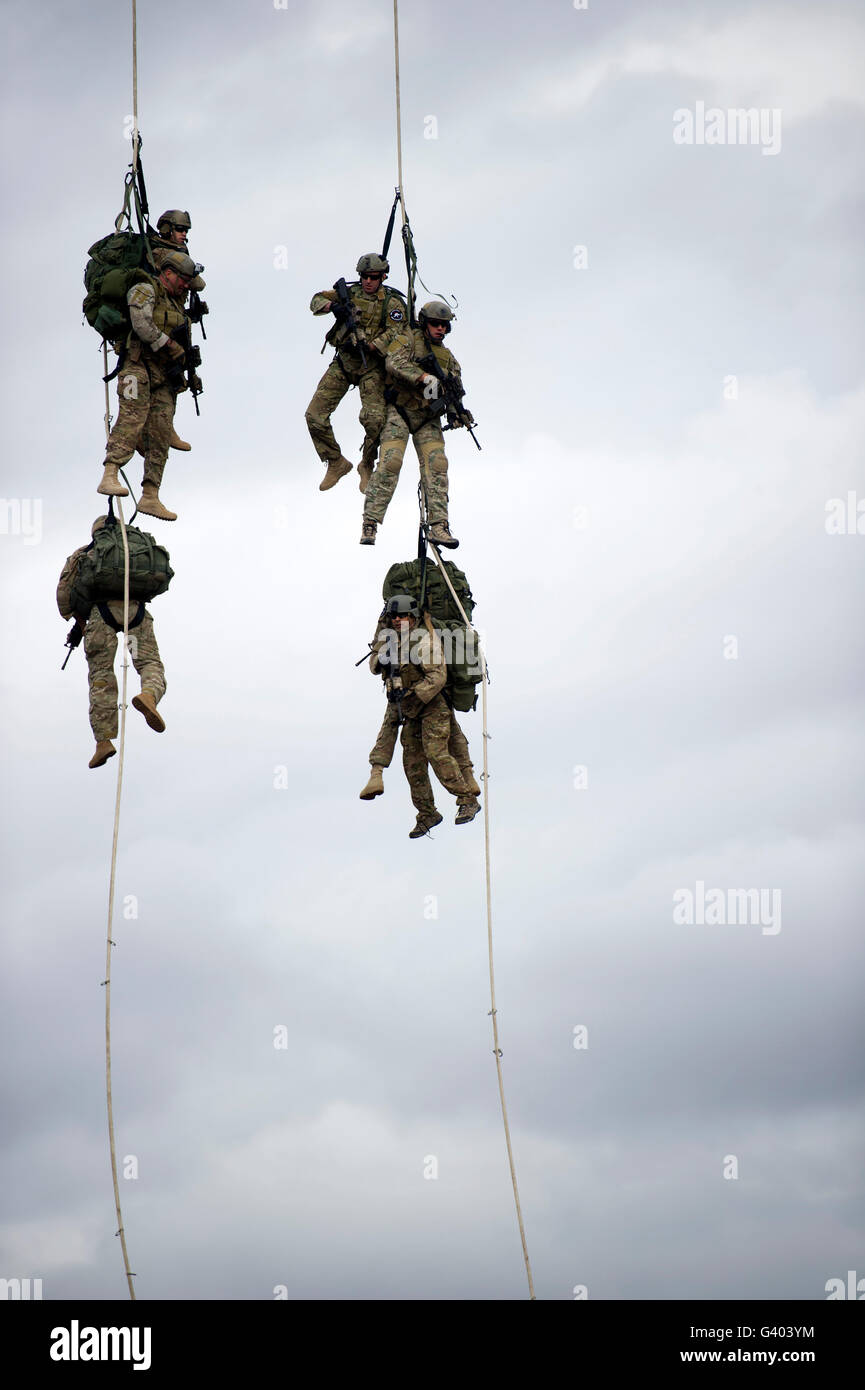 U.S. Soldiers are lifted off the ground by a CH-47 Chinook helicopter. Stock Photo