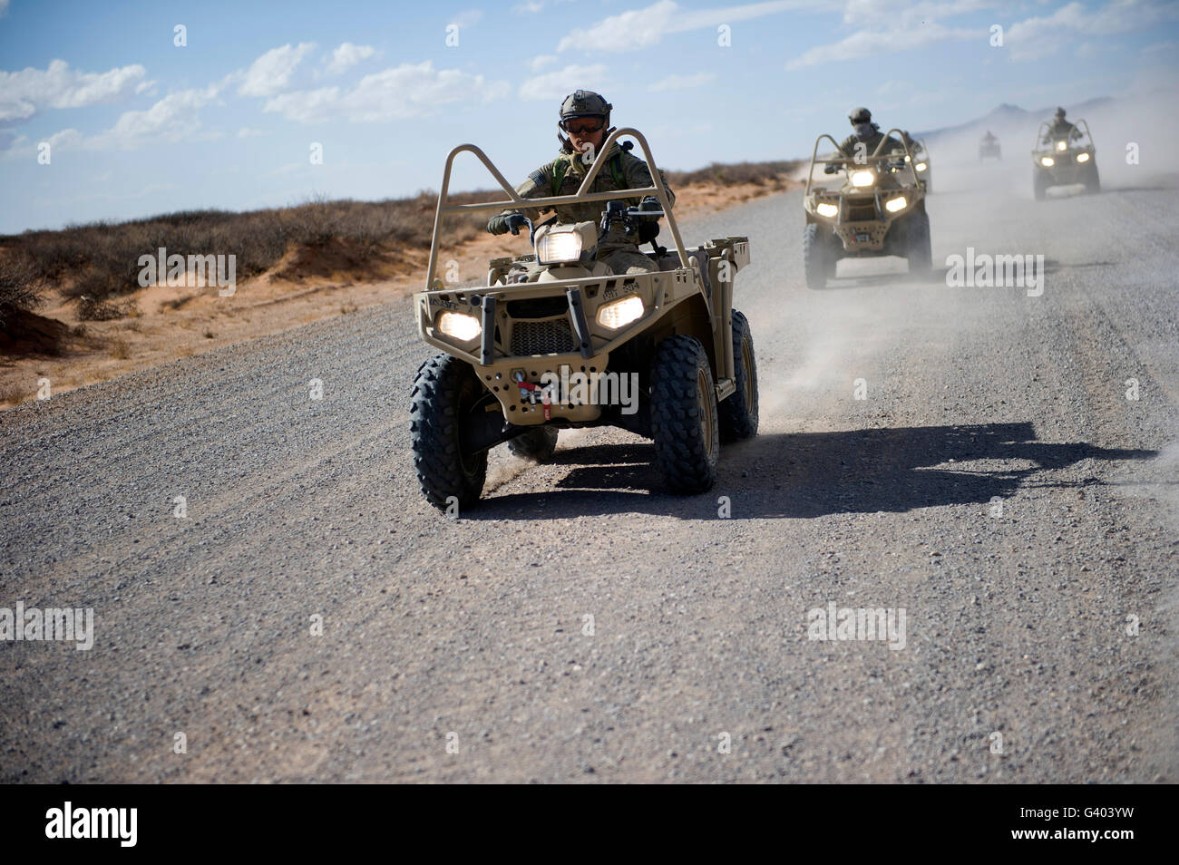 U.S. Soldiers perform maneuvers on a gravel road with an LTATV. Stock Photo